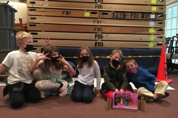 3 boys and 2 girls having a good time posing for a photo in the church