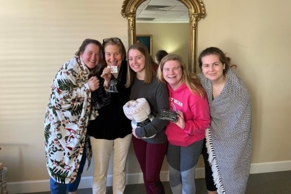 young women with leader huddled together with smiles