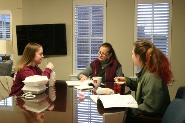 small group of young women studying