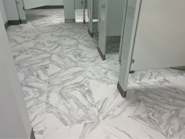 new white and gold flecked tiles on a bathroom floor