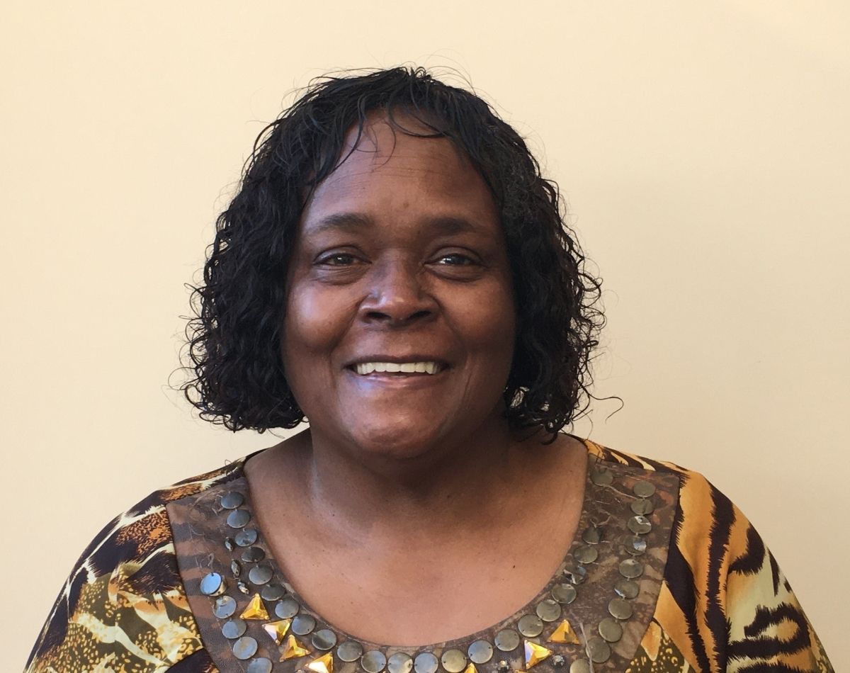 woman smiling in a staff headshot photograph