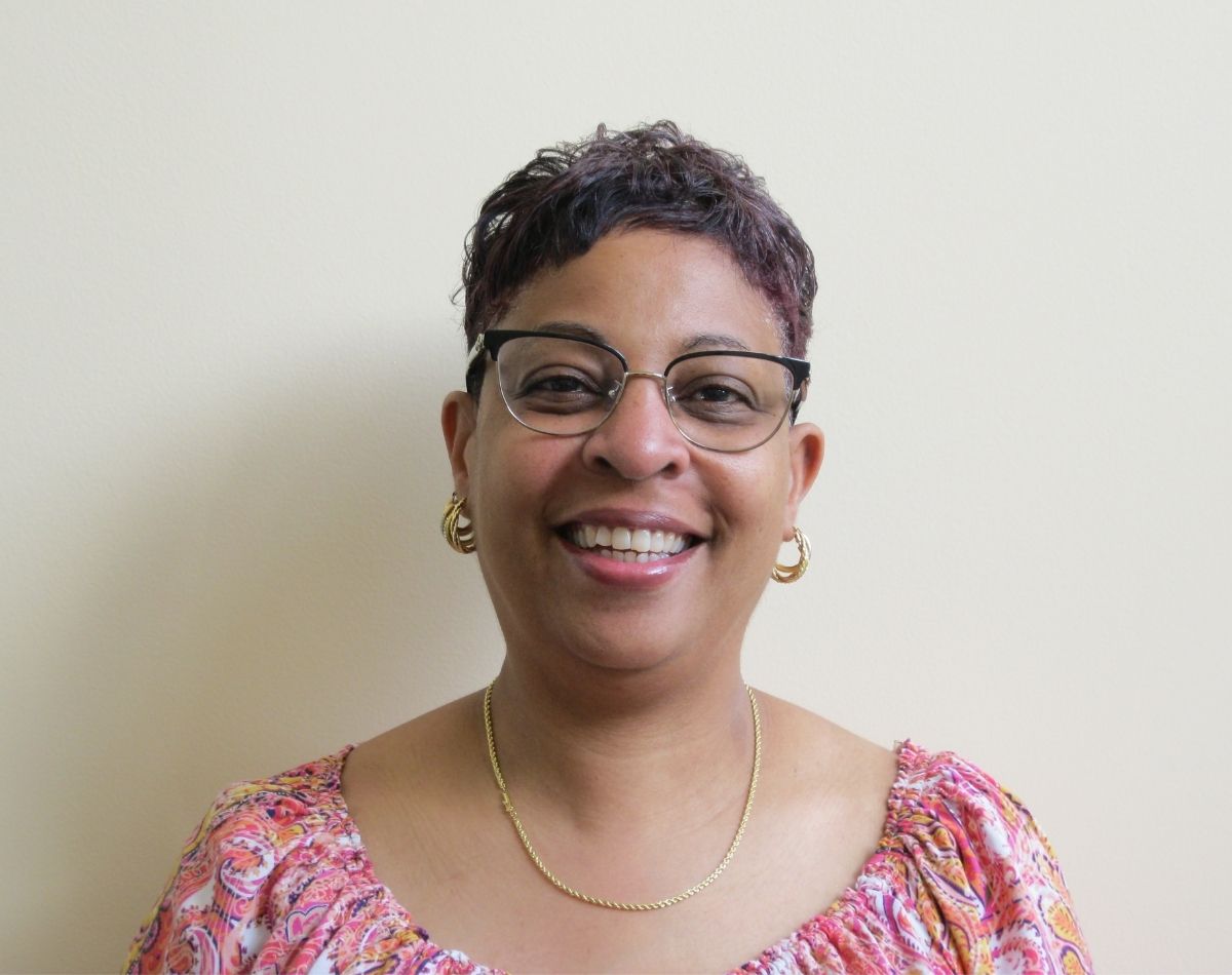 woman smiling in a staff headshot photograph