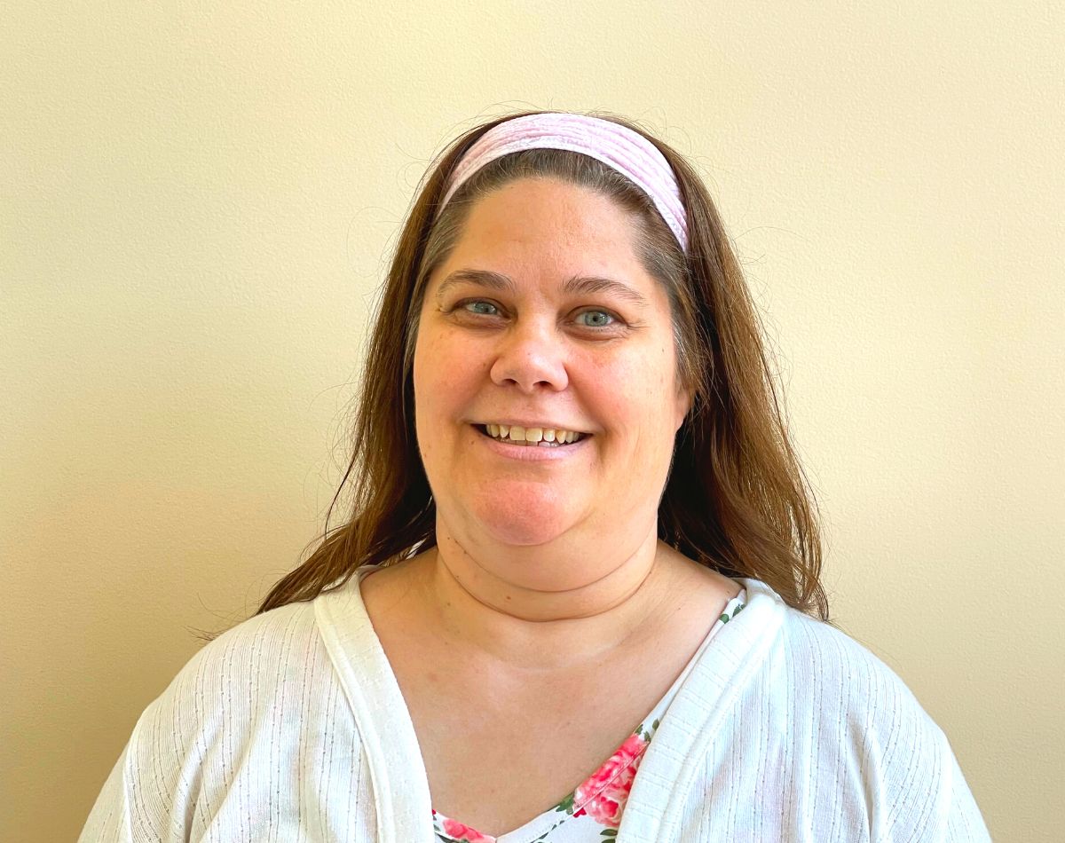 Michelle Wyman office administrator smiling for head shot photograph